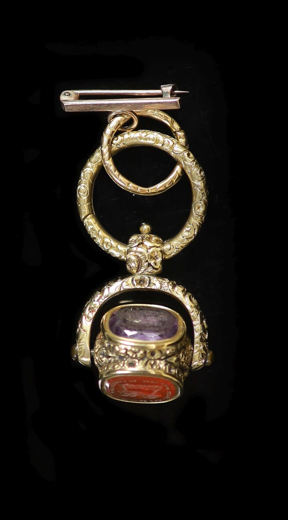 An early 19th century gold overlaid and three stone set swivelling fob seal